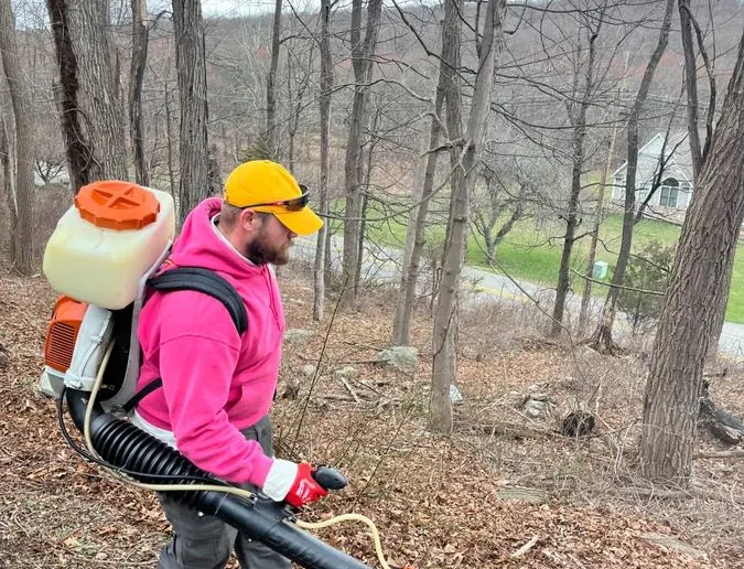 Pops Pest Control team treating wooded property for ticks and mosquitoes